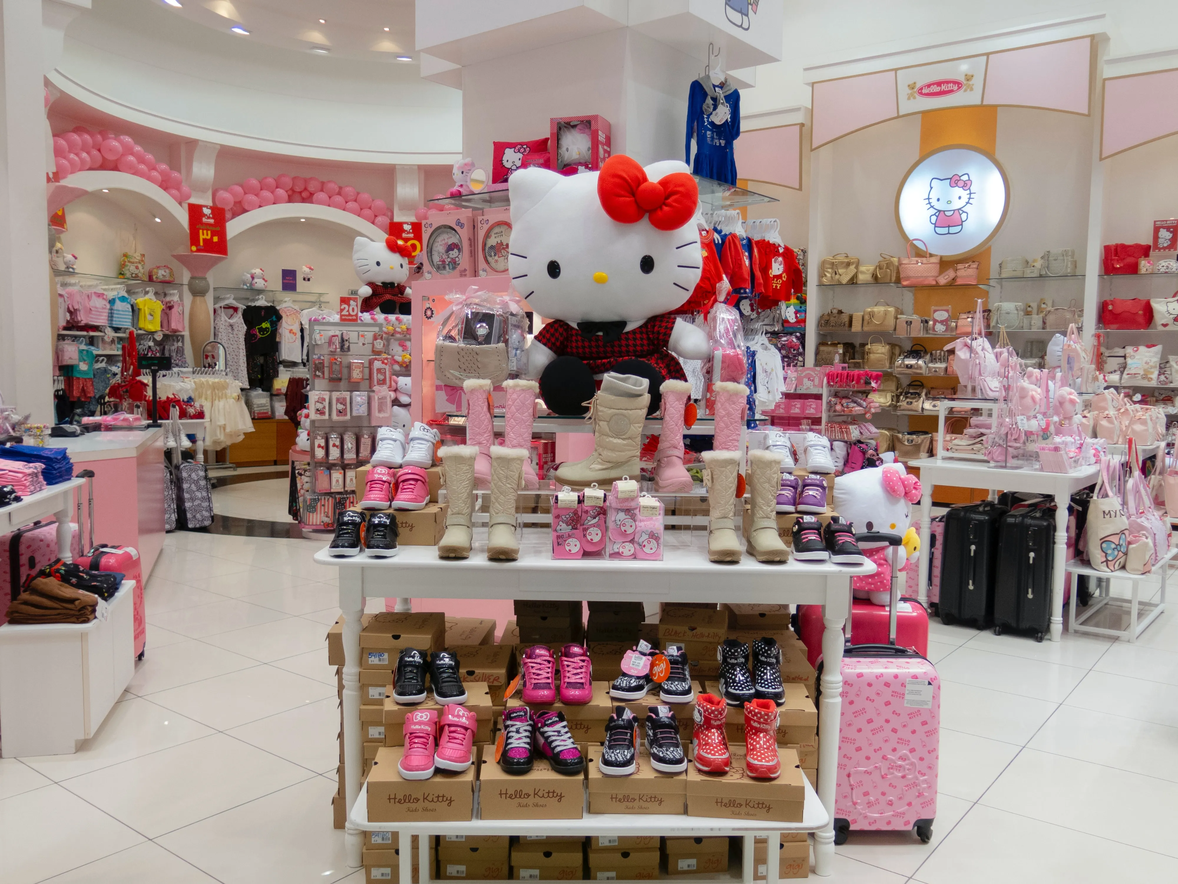 Hello Kitty-themed retail store showcasing a variety of children’s clothing, shoes, bags, toys,